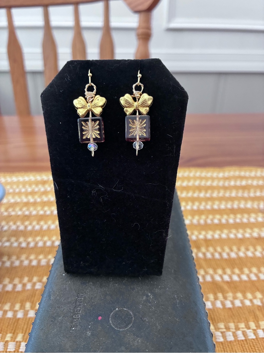 Gold Bow Earrings with Deep Garnet Accent